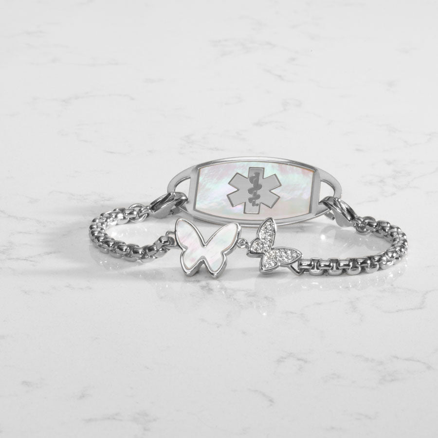 Silver box chain featuring a double butterfly centerpiece, inlaid with Mother of Pearl and cubic zirconia crystals. Attached to a silver medical ID tag with inlaid mother of pearl