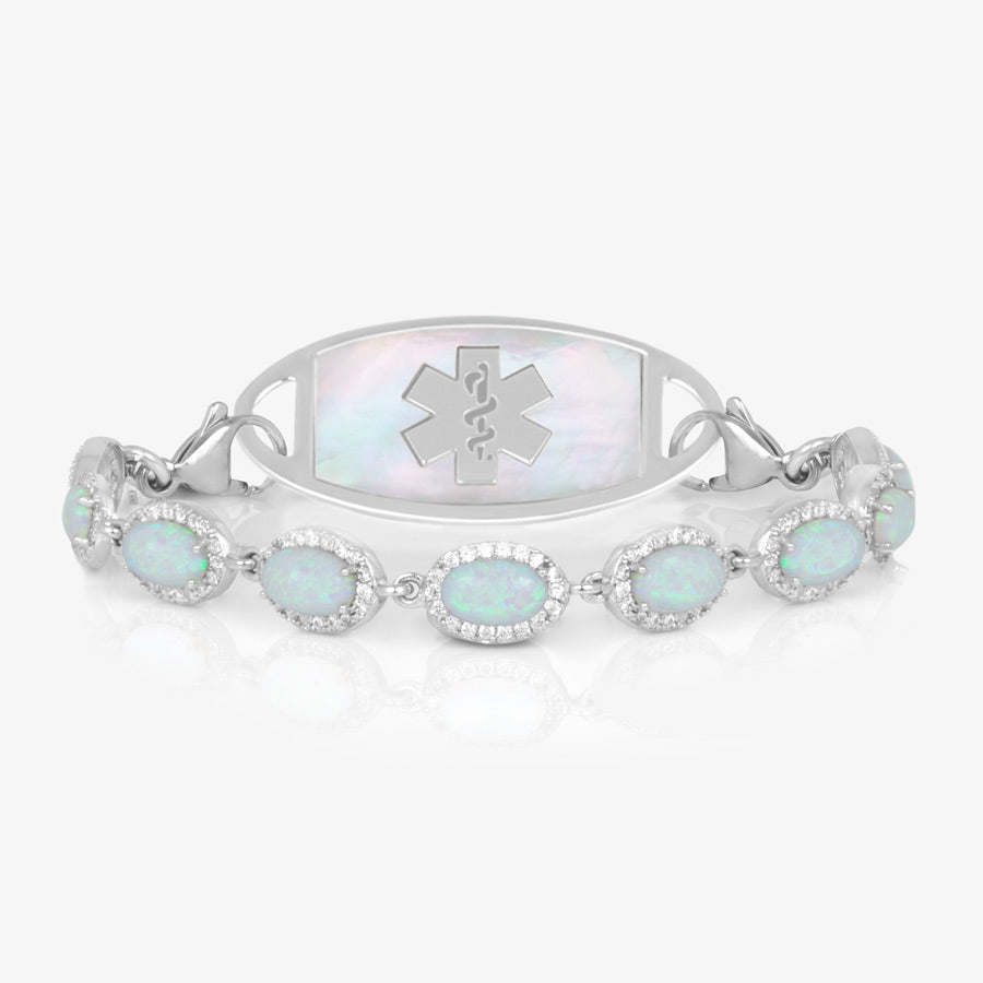 Bracelet with repeating links of simulated opals and czs. Shown with a silver tone tag with white med symbol.