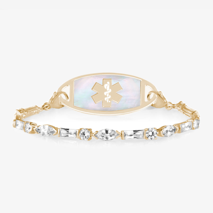 12 karat gold plated med ID tennis bracelet with round, oval, and rectangle clear cubic zirconia crystals and decorative med ID tag.