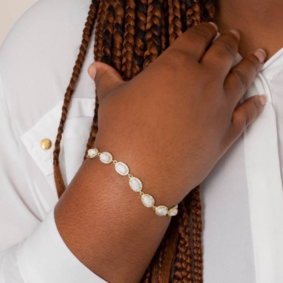 Woman wearing gold medical ID bracelet chain with howlite.