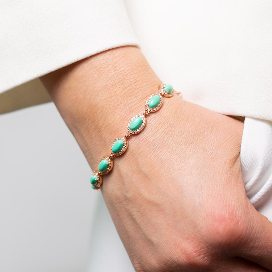 Woman wearing turquoise and rose gold medical ID bracelet chain