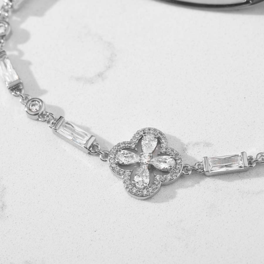 Up close image of clover shaped centerpiece and links with clear cubic zirconia stones