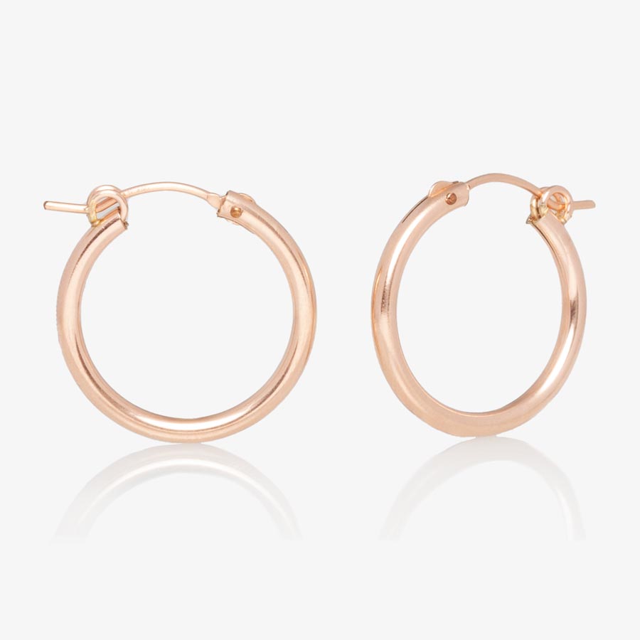 Rose gold tone hoop style earrings.