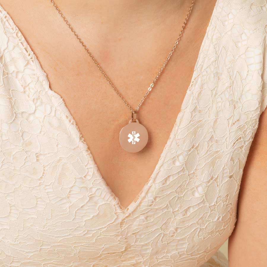 Woman wearing rose gold pendant medallion necklace