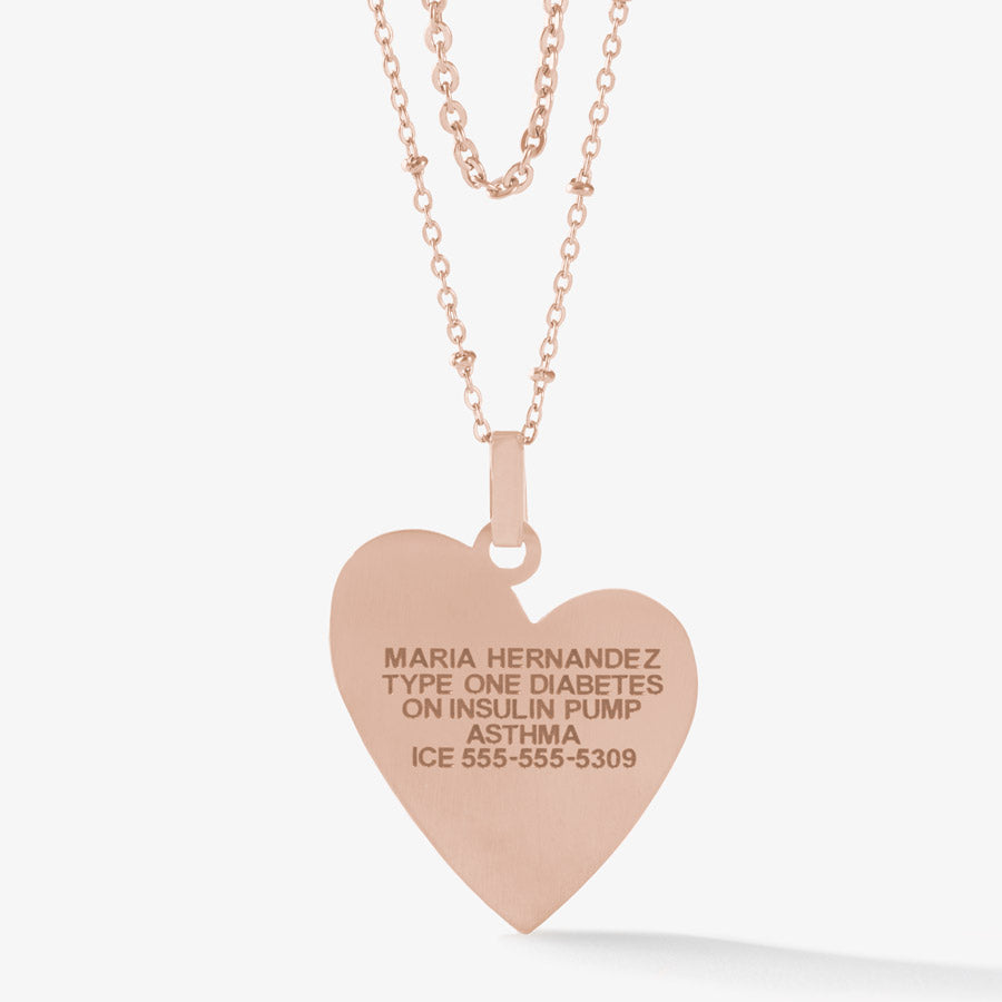 Premium laser engraving on rose gold tone heart pendant necklace.