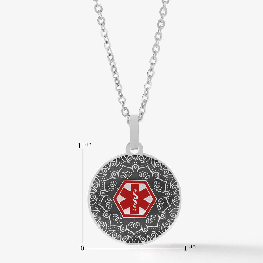 Scale of 1-1/4&quot; round silver tone stainless pendant on flat oval chain. Antique patina and clear layer over intricate pattern