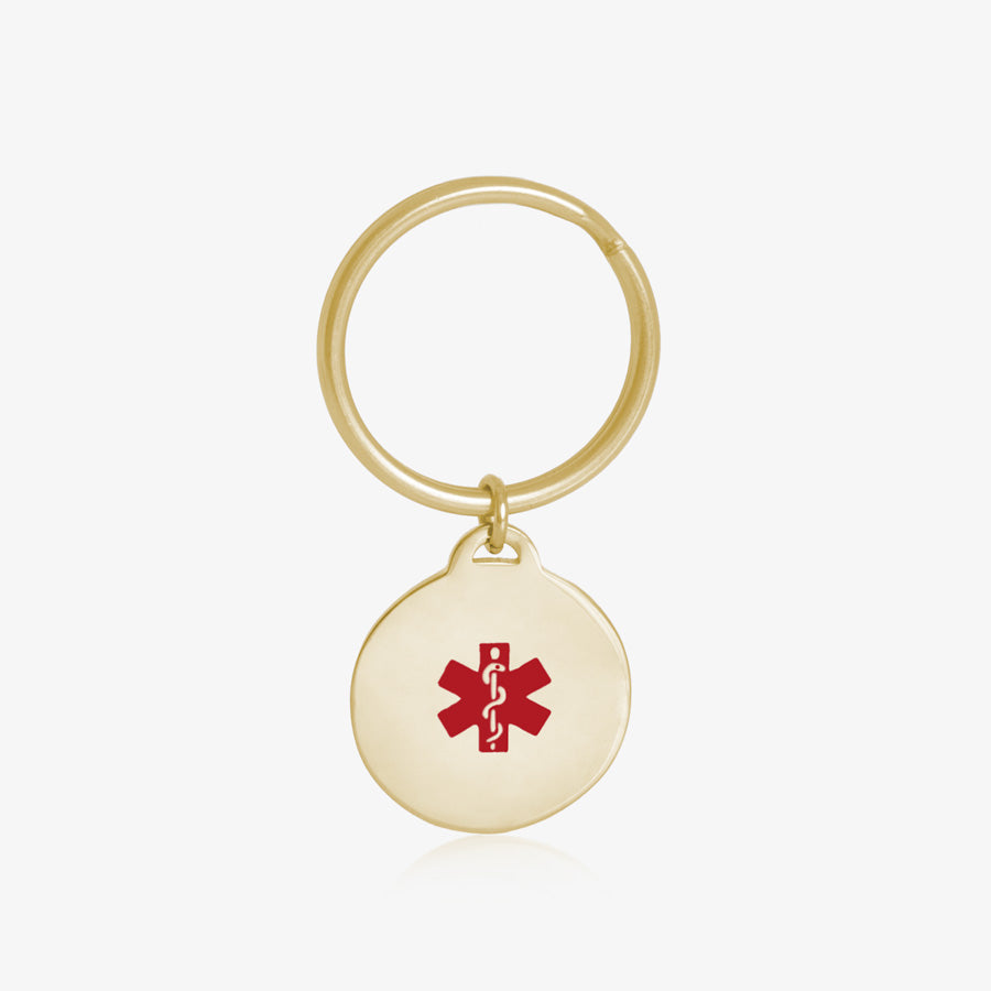 Key ID - gold tone circular charm with red medical caduceus symbol and gold keychain ring