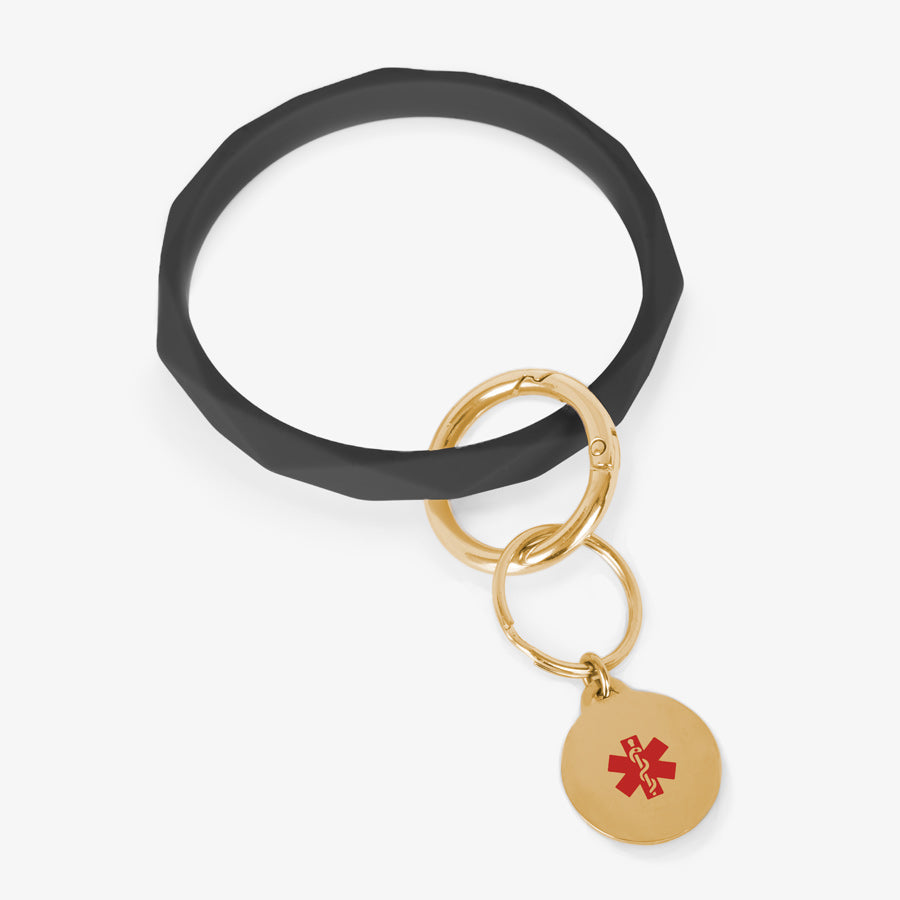 Black faceted silicone medical ID key ring wristlet with gold tone stainless steel medical alert charm.