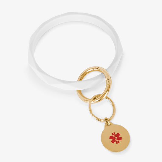 White faceted silicone medical ID key ring wristlet with gold tone stainless steel medical alert charm.