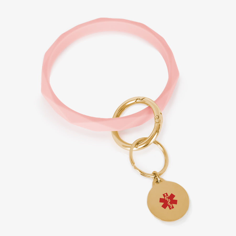 Soft pink faceted silicone medical ID key ring wristlet with gold tone stainless steel medical alert charm.