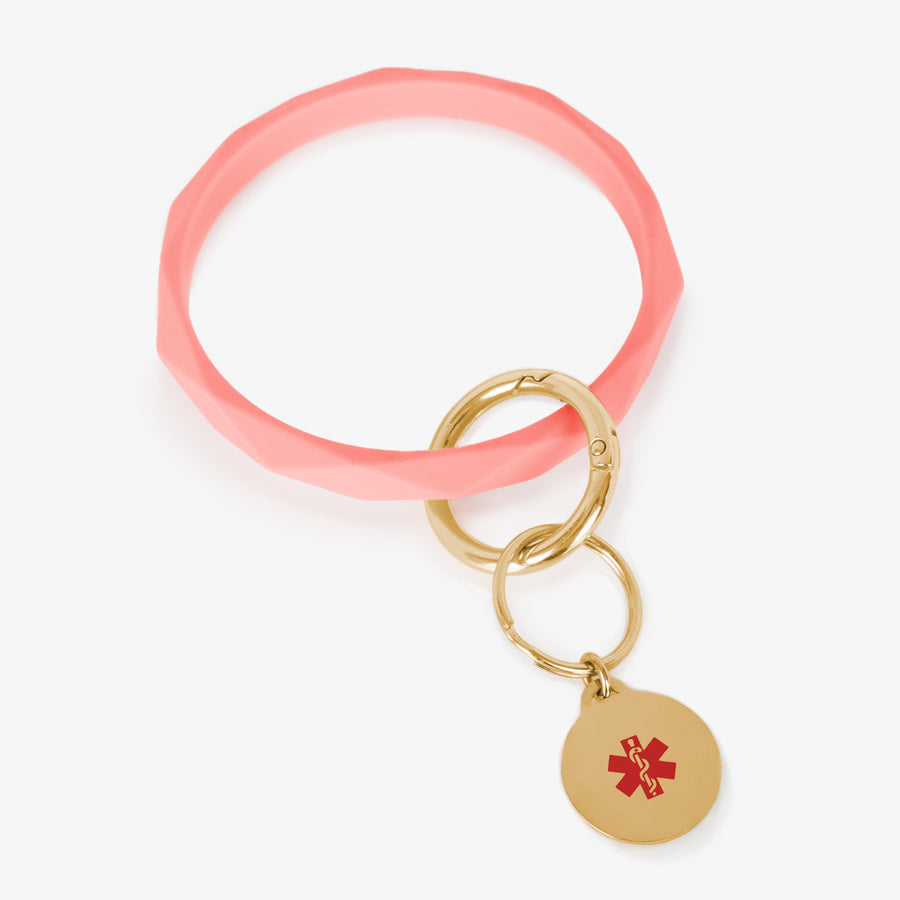 Coral faceted silicone medical ID key ring wristlet with gold tone stainless steel medical alert charm.