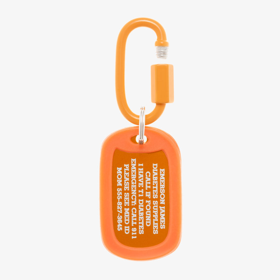 Carrot aluminum bag tag with engraving example and coordinating silicone silencer on matching carabiner clip.