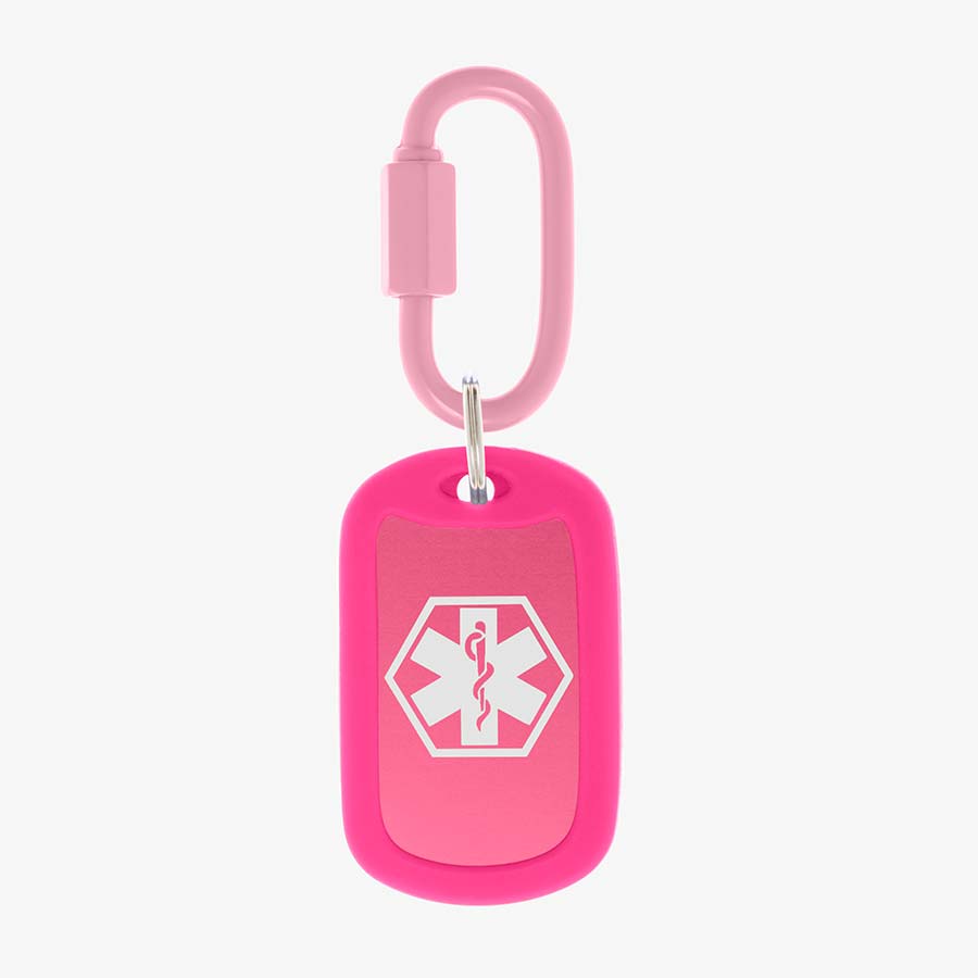 Bright pink aluminum bag tag with white medical symbol and coordinating silicone silencer on matching carabiner clip.