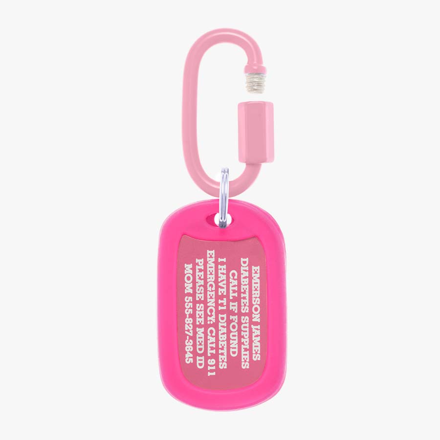 Bright pink aluminum bag tag with engraving example and coordinating silicone silencer on matching carabiner clip.