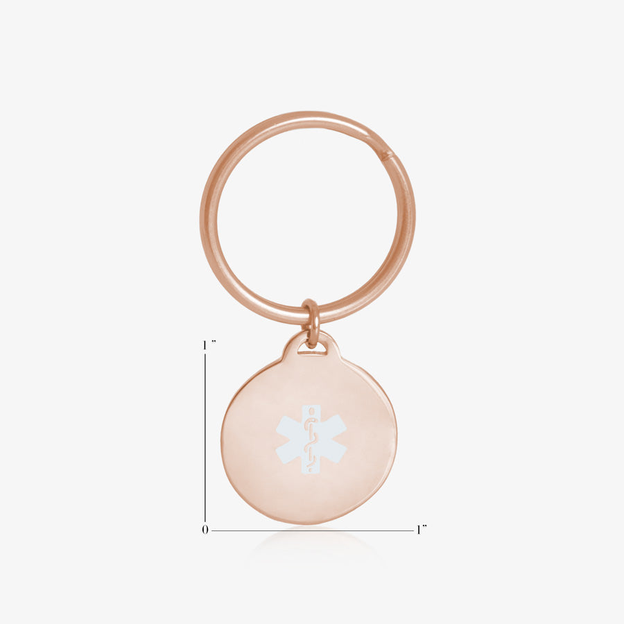 Measurements of circle medical alert key chain in rose gold with white medical symbol